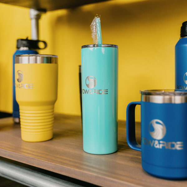 A shelf with several different cups and bottles.