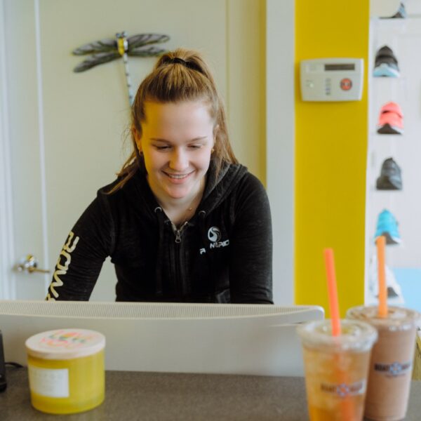 A woman sitting at the counter of a restaurant.