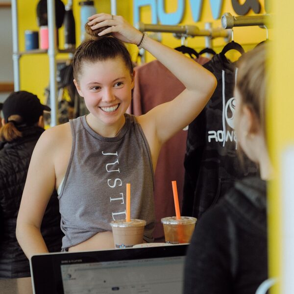 A woman is standing in front of a counter.